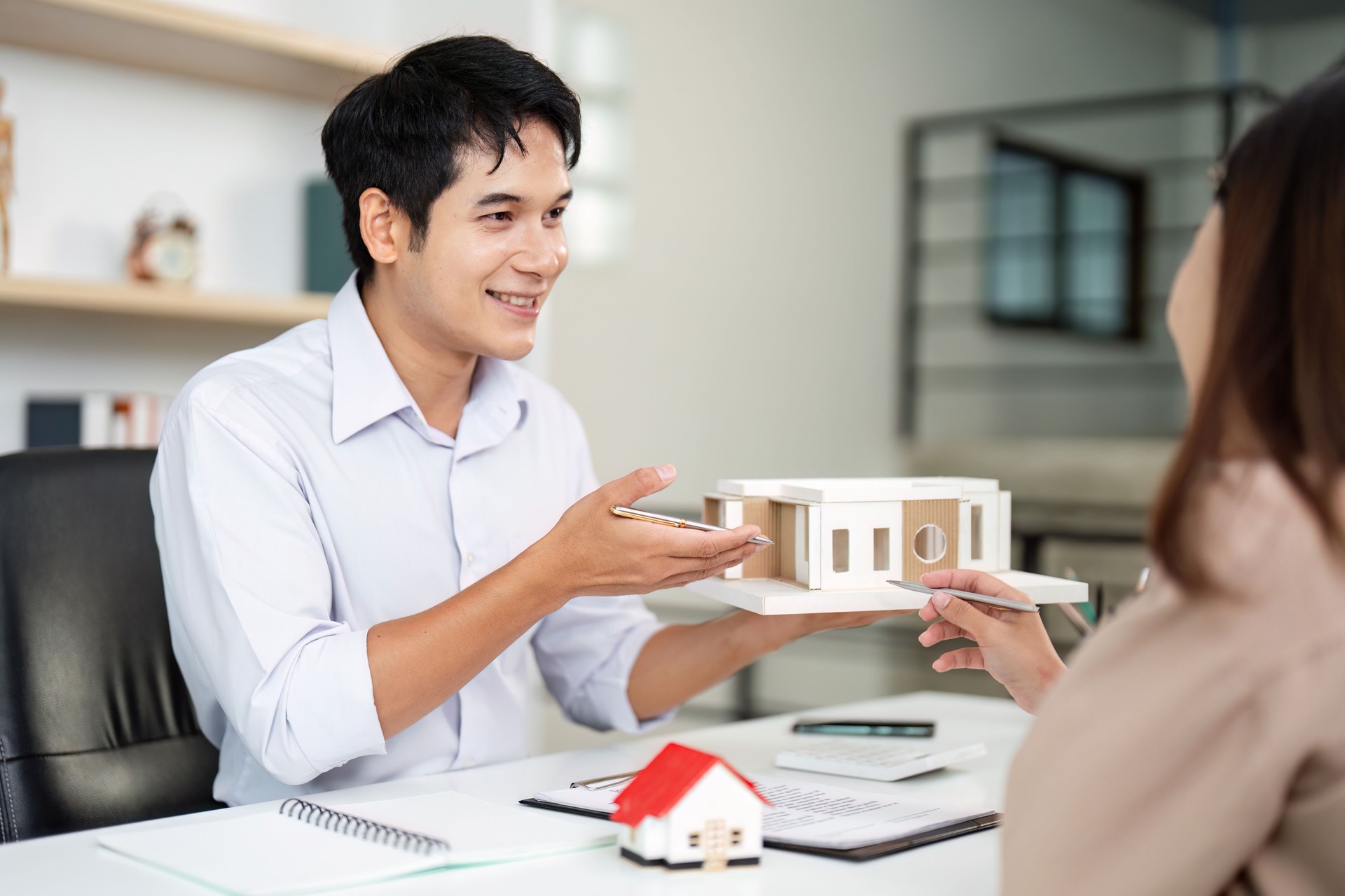 Real Estate Agent Presenting Model Home to Client